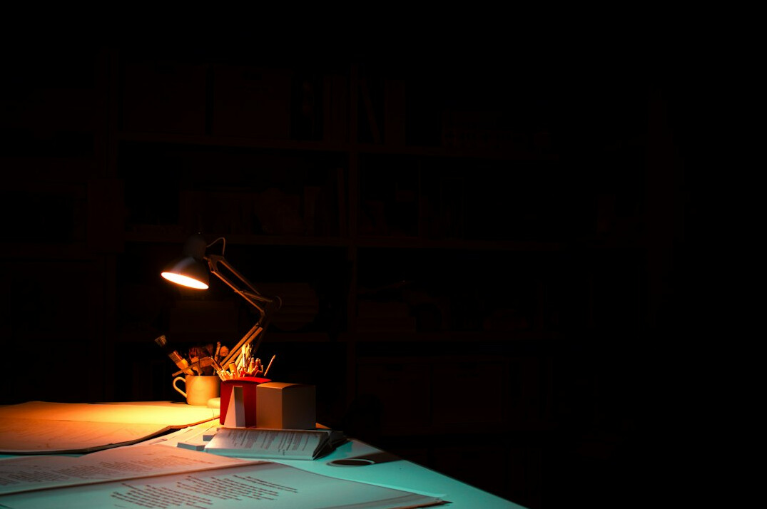 Open notebook and pen on a wooden desk